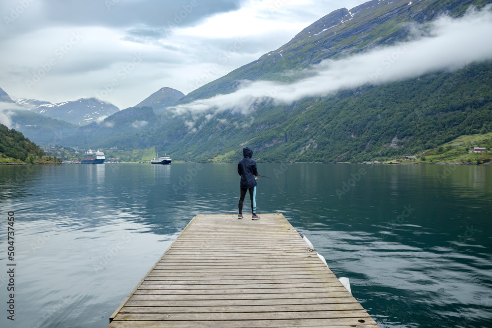 Woman fishing on Fishing rod spinning in Norway. Woman fishing on Fishing rod spinning in Norway.