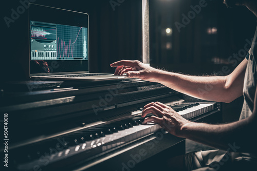 A man composer, producer, arranger, songwriter, musician hands arranging music. photo