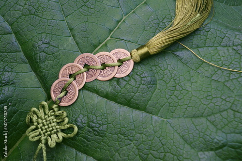 Chinese feng shui coins on a green background.