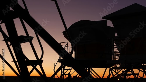 Lifeguard stand, hut or house on ocean beach after sunset, California coast, USA. Life guard tower or station silhouette in twilight dusk. Contrast beachfront watchtower for surfing safety on shore.