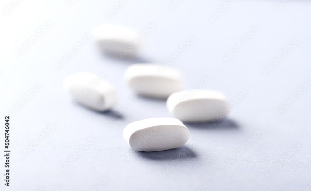 Lysine tablets. Concept for a healthy dietary supplementation. Nervous System Support. Soft focus. Bright background. Close up. Copy space. Lysine tablets. Concept for a healthy dietary supplementation. Nervous System Support. Soft focus. Bright background. Close up. Copy space.