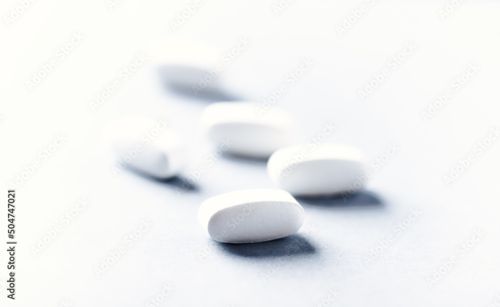 Lysine tablets. Concept for a healthy dietary supplementation. Nervous System Support. Soft focus. Bright background. Close up. Copy space. Lysine tablets. Concept for a healthy dietary supplementation. Nervous System Support. Soft focus. Bright background. Close up. Copy space.