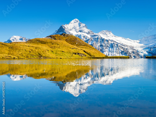 High mountains and reflection on the surface of the lake. Mountain valley wit...
