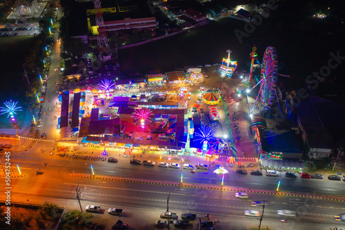 Aerial top view of amusement park in night temple fair, and night local markets. People walking street, Colorful tents in Bangkok city, Thailand. Retail shops