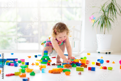 Child playing with toy blocks. Toys for kids.