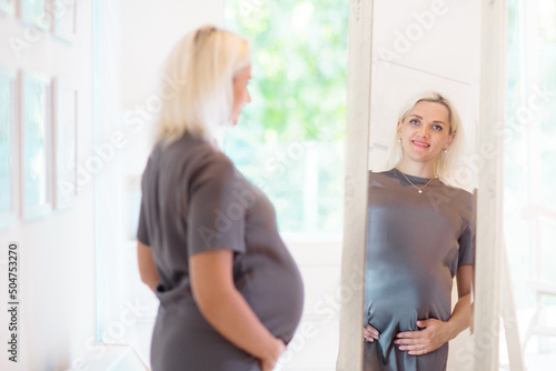 Pregnant woman at home. Young expecting mother.