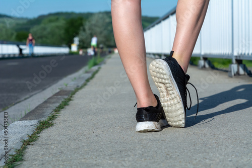 Running feet on the street closeup on the shoe. Women Fitness Jogging Training 