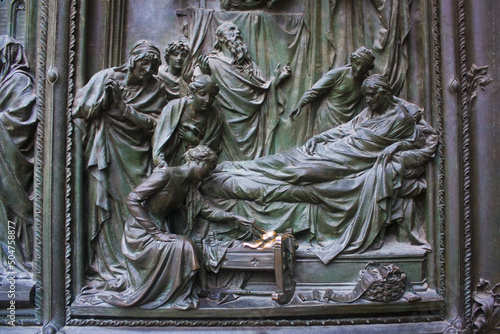Pieta scenes on the bas relief of Milan Cathedral door in Milan