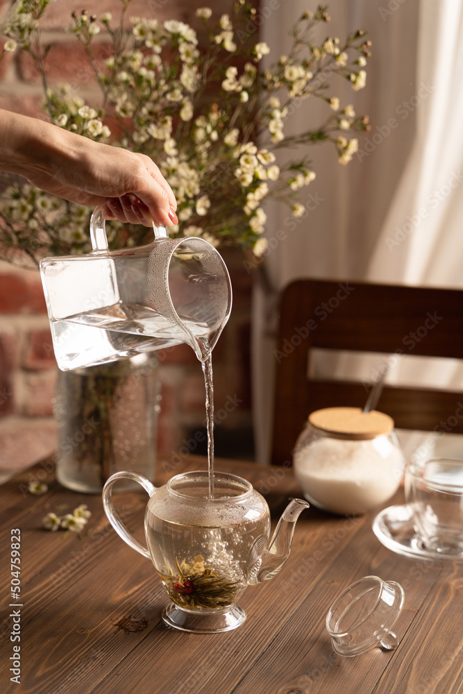 brewing flower tea in a glass teapot lifestyle brewing flower tea in a glass teapot lifestyle