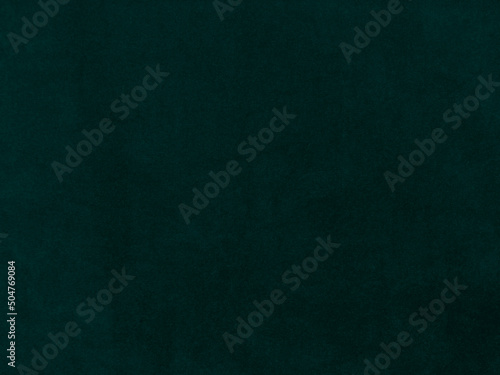Dark green old velvet fabric texture used as background. Empty green fabric background of soft and smooth textile material. There is space for text.