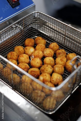 croquetas y bocaditos de queso en la freidora photo