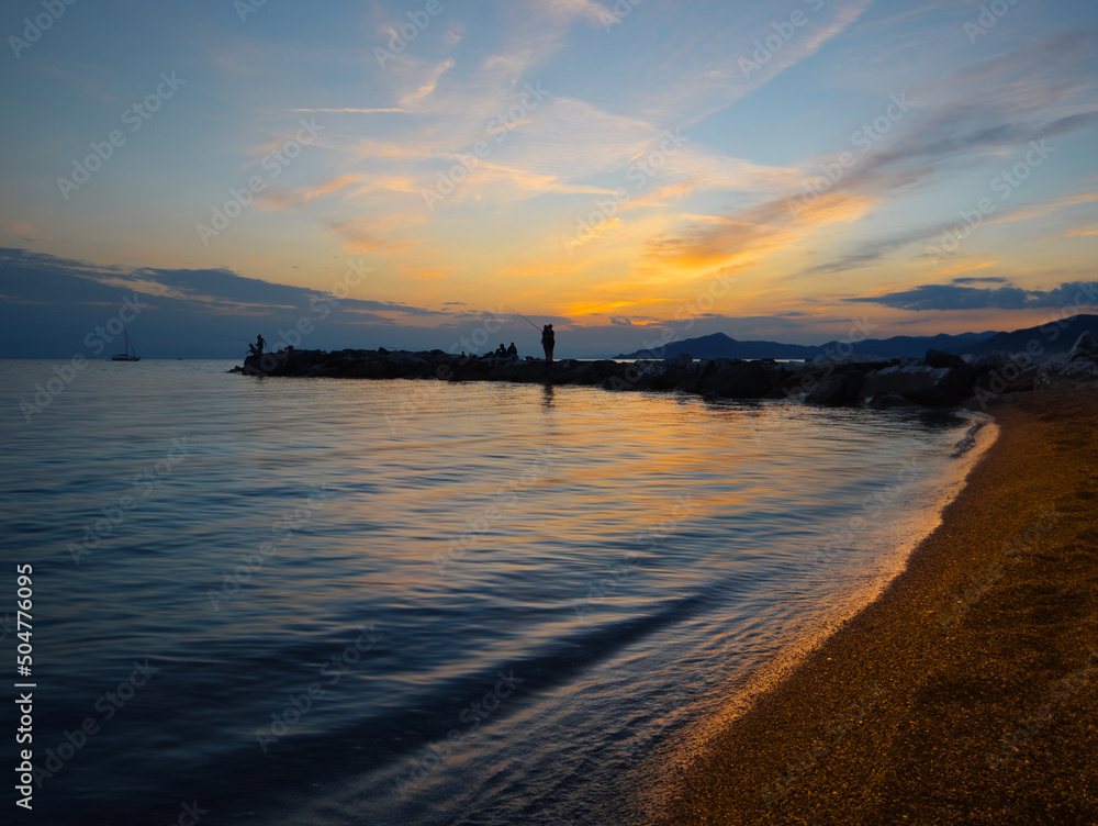Beautiful sunset on a free beach in Liguria