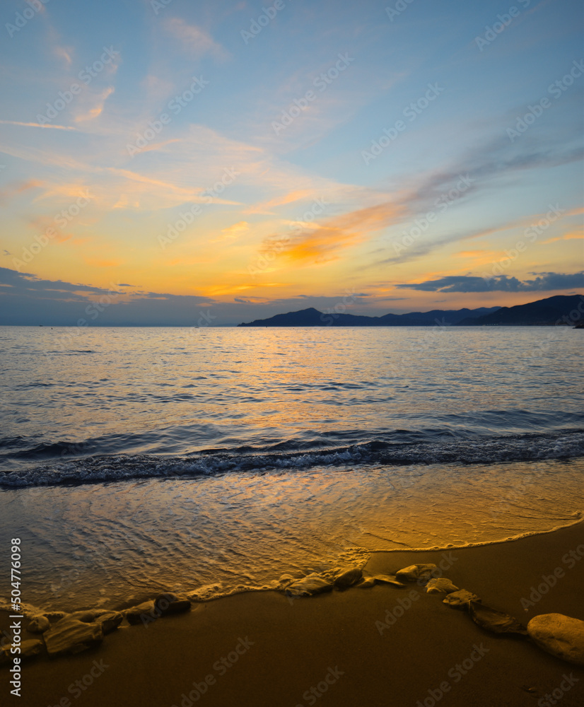 Beautiful sunset on a free beach in Liguria Beautiful sunset on a free beach in Liguria