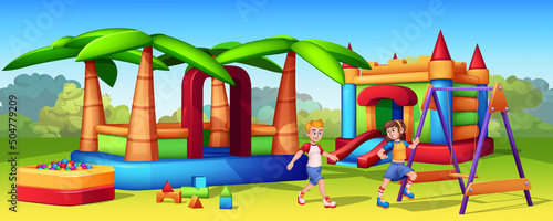 Cartoon gaming inflatable slides in amusement park. Bouncy castle, air trampoline for kids on play area in park. Girl and boy playing in childish playground. Swings and dry pool with balls for kid.