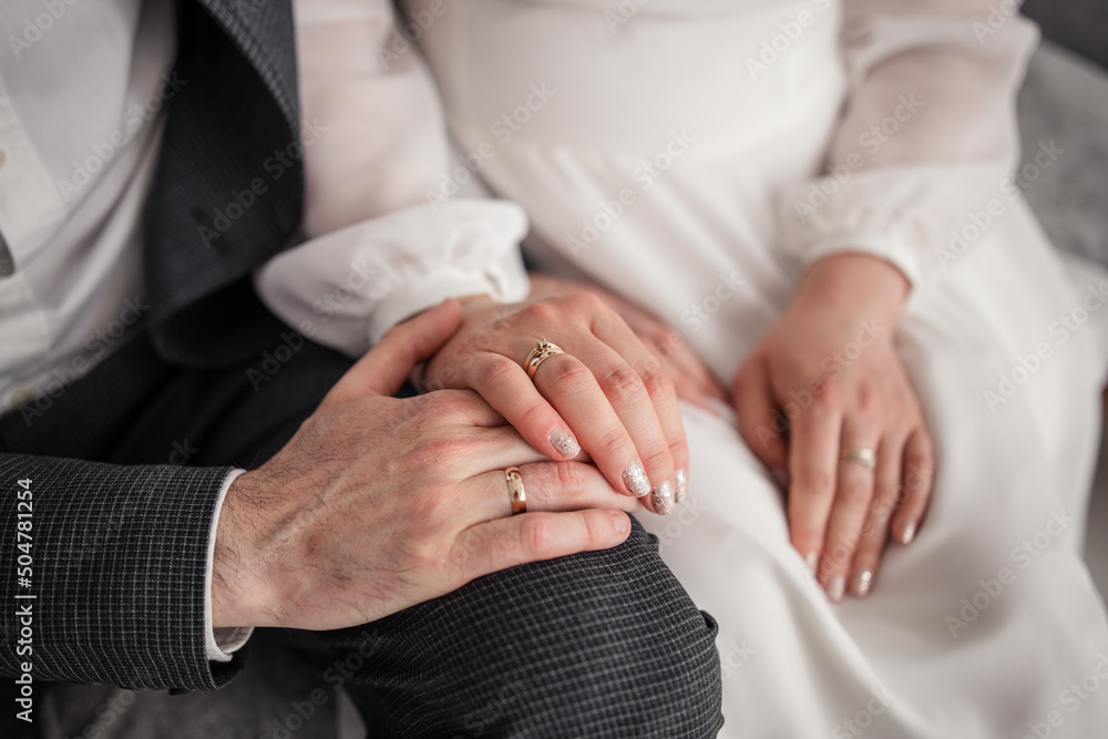 woman's hand on a chair with a golden ring at the bride woman's hand on a chair with a golden ring at the bride