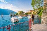 Beautiful blonde girl on The Walk of Lovers in Varenna, a pedestrian path over water, in the Lombard village of lovers on Lake Como. Varenna is the perfect place for a romantic weekend.