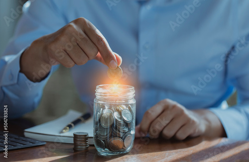 Business saving money concept. Hand of business holding money coins,