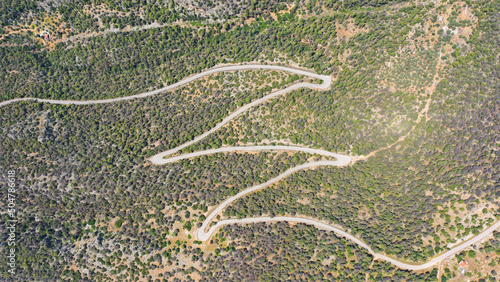 Aerial drone top view photo of snake road passing over mountain