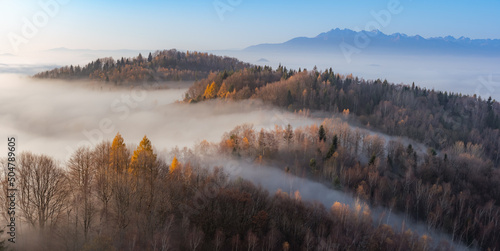 Fototapeta Naklejka Na Ścianę i Meble -  Misty autumn mountains landscape in the morning, Poland, Beskidy mountains and Tatra mountains in the background