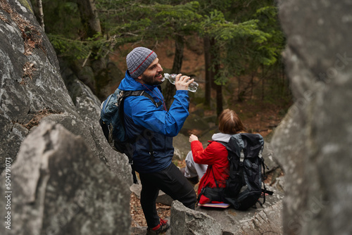 Tourist making a sip from bottle during hiking tour
