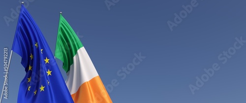 Flags of the European Union and Ireland on flagpoles on side on a blue background. Place for text. Flag. EU. Dublin. 3d illustration.