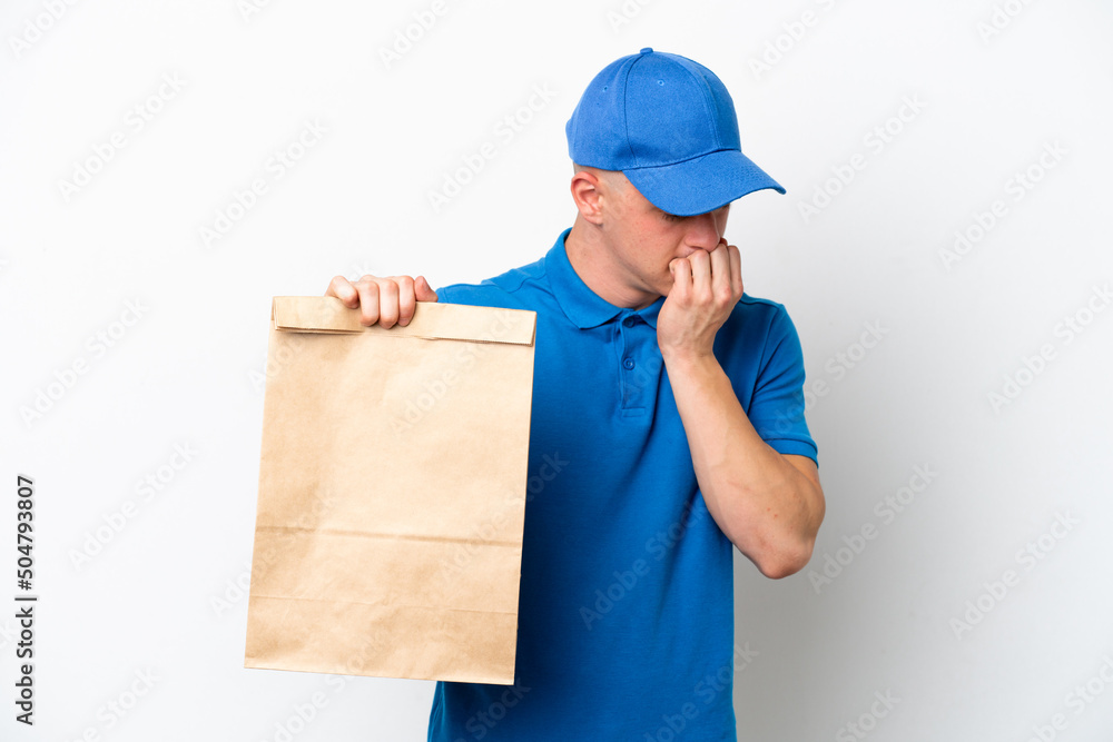 Young Brazilian man taking a bag of takeaway food isolated on white background having doubts Young Brazilian man taking a bag of takeaway food isolated on white background having doubts