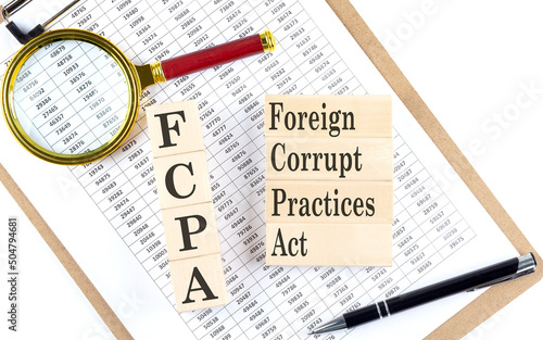 Принти на полотні FCPA Foreign Corrupt Practices Act text on wooden block on chart background