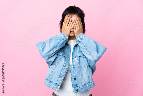 Young Uruguayan woman over isolated pink background covering eyes by hands