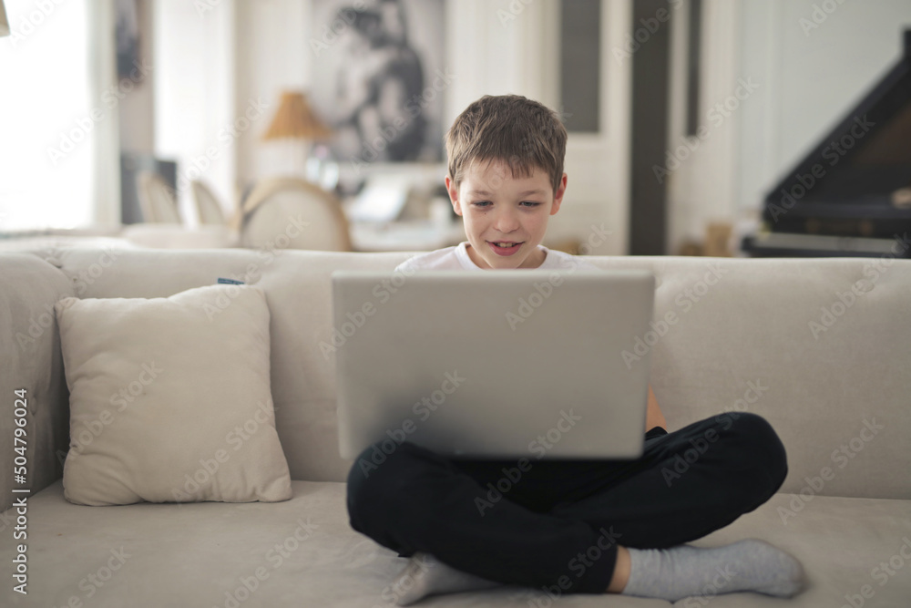 child uses a laptop at home child uses a laptop at home