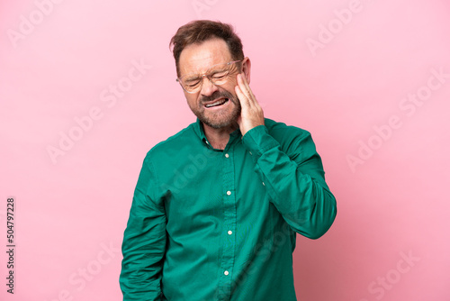 Middle age caucasian man isolated on pink background with toothache © luismolinero