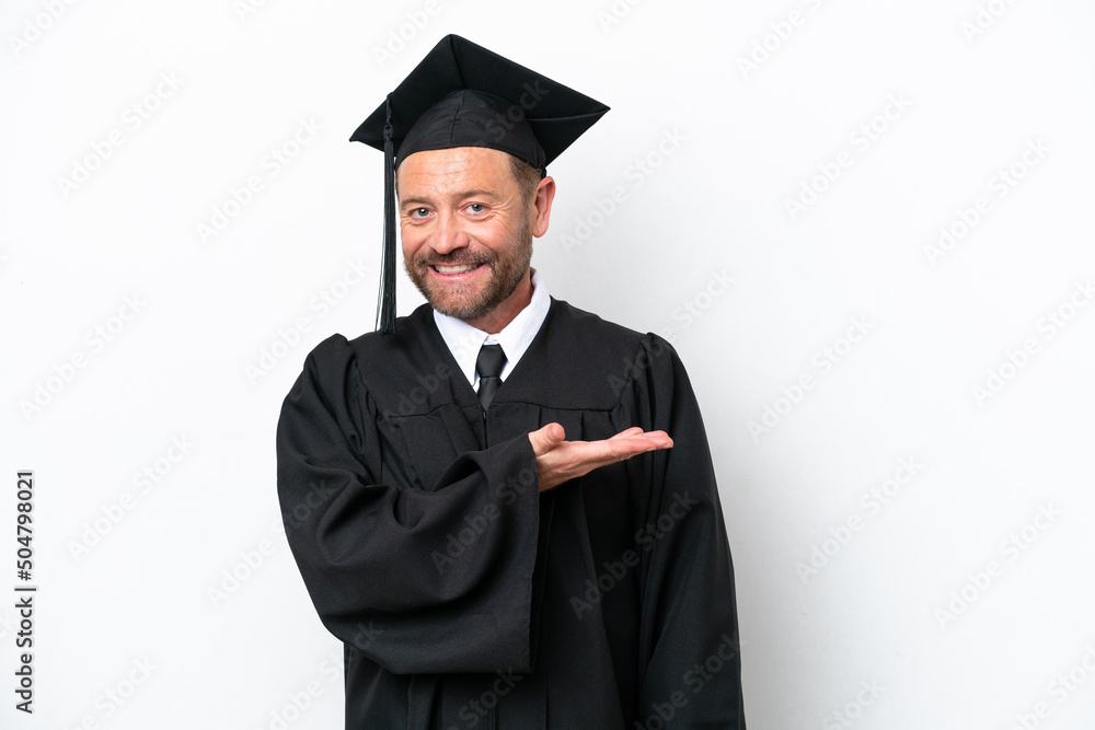 Middle age university graduate man isolated on white background presenting an idea while looking smiling towards Middle age university graduate man isolated on white background presenting an idea while looking smiling towards