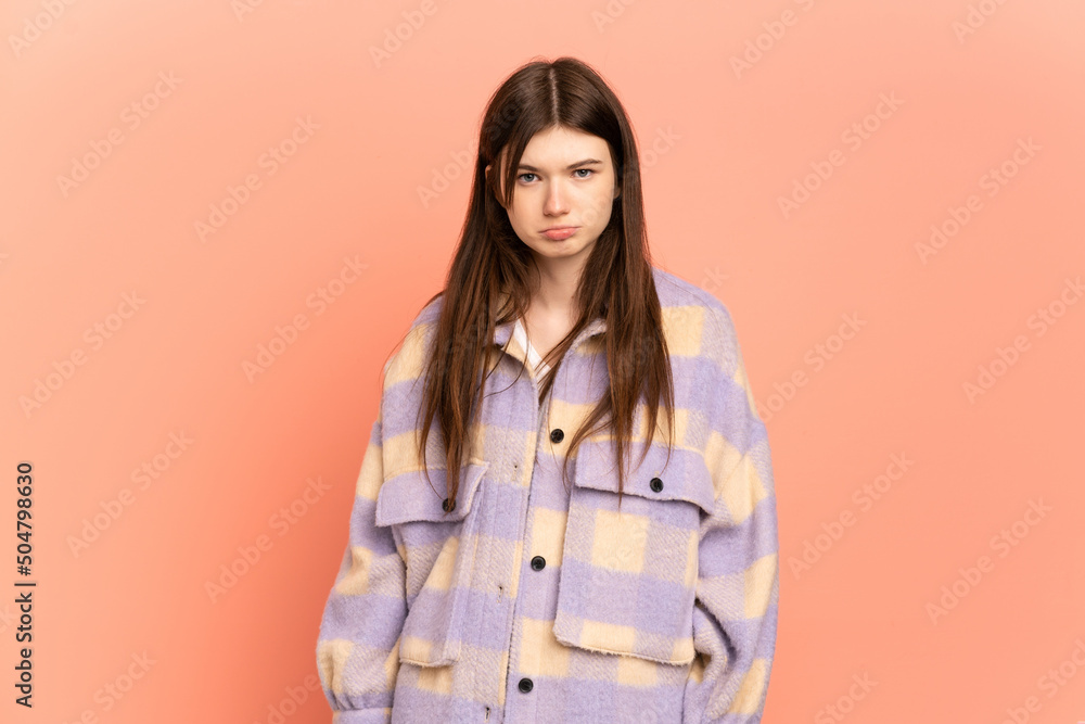 Young Ukrainian girl isolated on pink background with sad expression Young Ukrainian girl isolated on pink background with sad expression