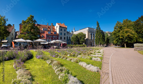 Livu square in Riga, Latvia, panoramic image with wave pattern of flowerbeds on foreground. The square was once a riverbed.