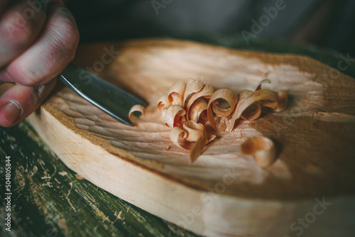 Tableau sur toile Wood carving in creativity workshop, carving craftsmanship, wooden shaving, trad