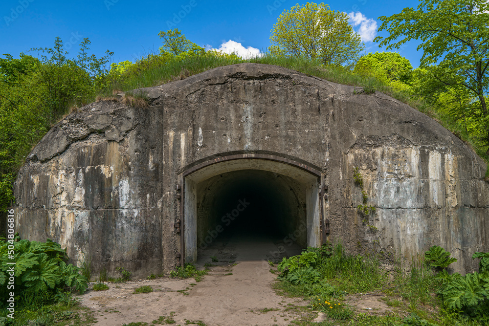 Military underground concrete beton tunnel entrance. Dark hole of subterranean grotto exit