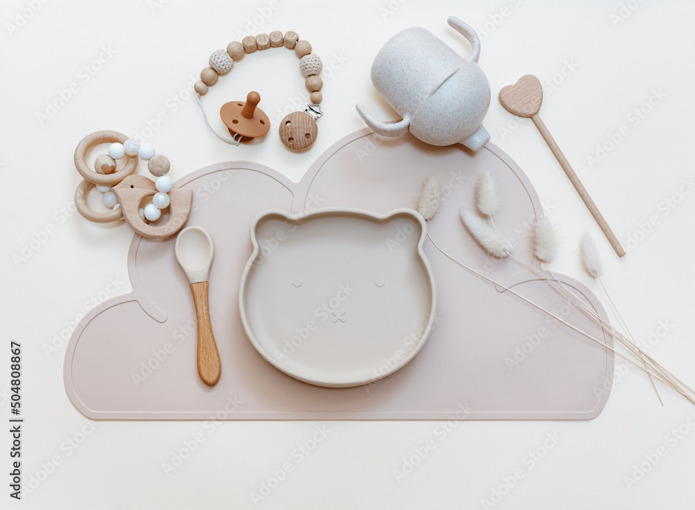 Silicone dishware on light background. Serving baby, first feeding concept. Kids tableware. Flat lay, copy space, top view - obrazy, fototapety, plakaty 