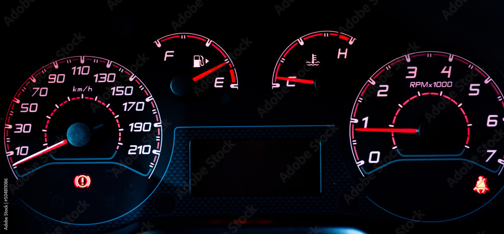 Car dashboard with speedometer, tachometer, fuel gauge, seat belt reminder