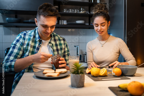Young couple caucasian man and woman husband and wife or boyfriend and girlfriend brother and sister students preparing breakfast in the kitchen at home real people copy space daily morning routine