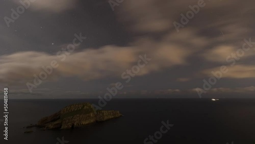 Timelapse over Deva Island at night with clouds, in the Council of Castrillón, Asturias, Spain photo