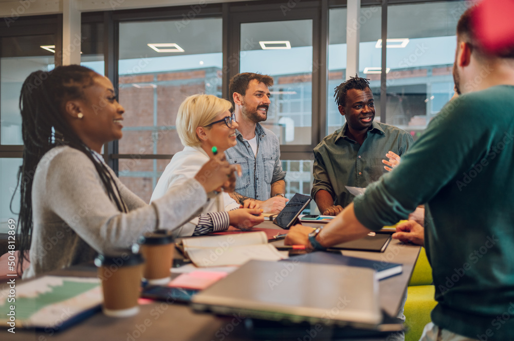 Multiracial business team working together and having a meeting in the office Multiracial business team working together and having a meeting in the office