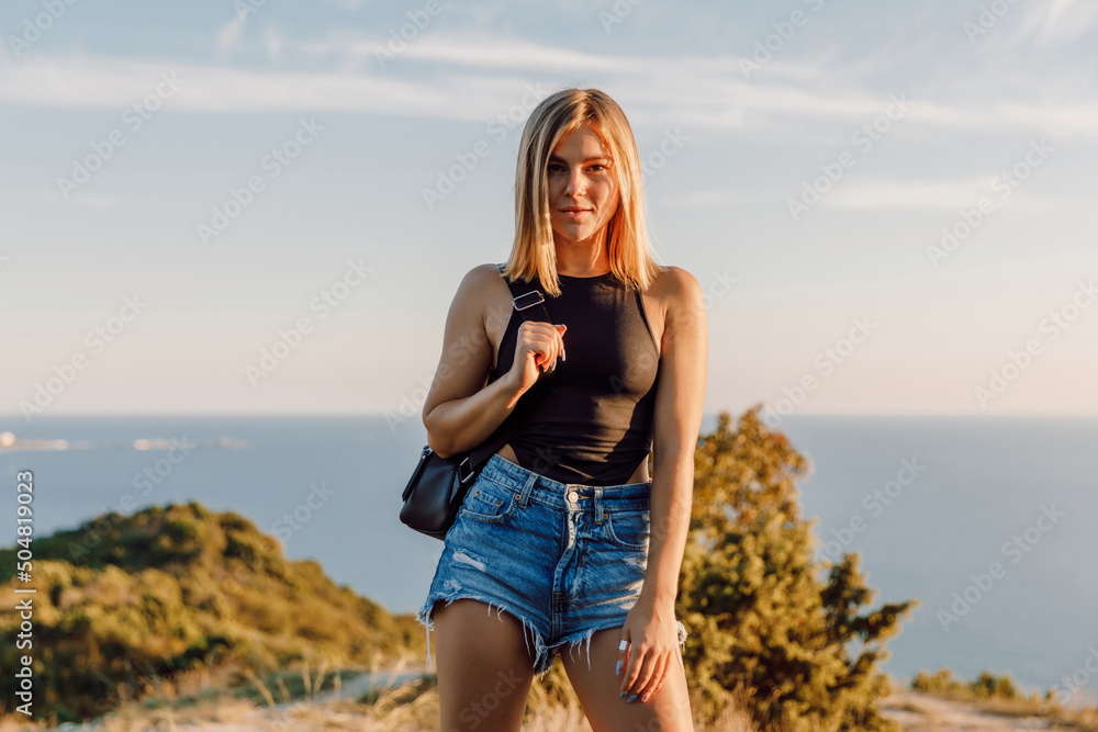 Portrait of sporty woman in shorts posing outdoor.