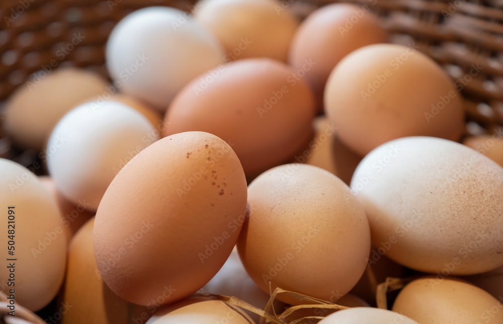 fresh eggs inside a wooden basket at agriculture farm. fresh eggs inside a wooden basket at agriculture farm.
