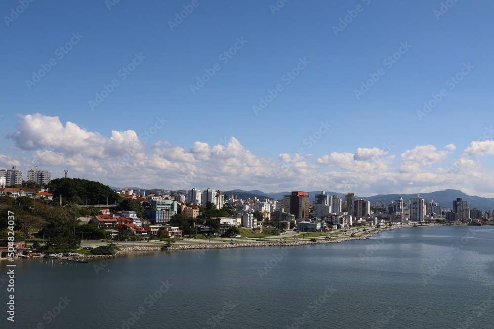 City on the ocean coast  sea and mountains promenade sandy Brazil Florianopolis beautiful view from the water to tall buildings from a height