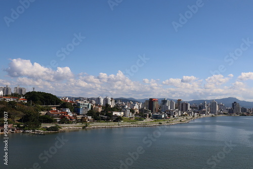 City on the ocean coast  sea and mountains promenade sandy Brazil Florianopolis beautiful view from the water to tall buildings from a height