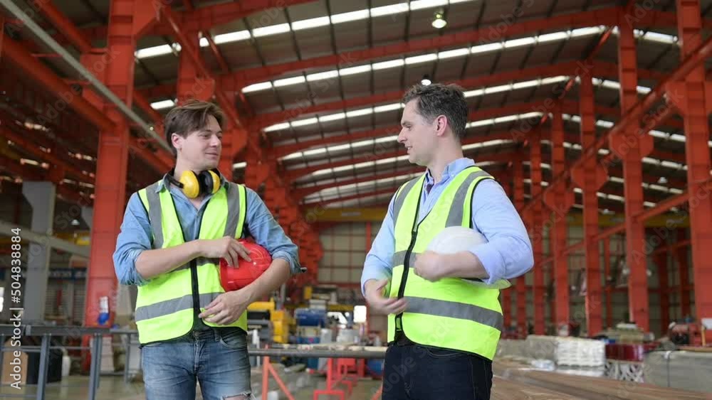 The young engineers greeted each other before going in for an inspection. In the sheet metal forming factory The young engineers greeted each other before going in for an inspection. In the sheet metal forming factory