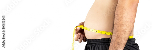 A chubby Asian man measures his waist with a yellow tape measure,panoramic horizontal copy space on white background,Healthcare concept photo