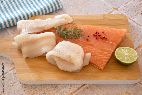 Canvas Print top view of salmon and halibut fillet steak on wooden board