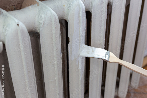 Painting radiators with a special brush photo