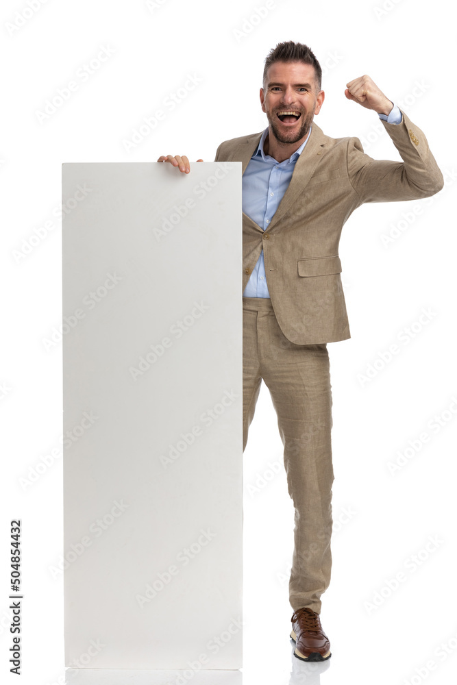 enthusiastic man in his 40s holding and presenting board and celebrating enthusiastic man in his 40s holding and presenting board and celebrating