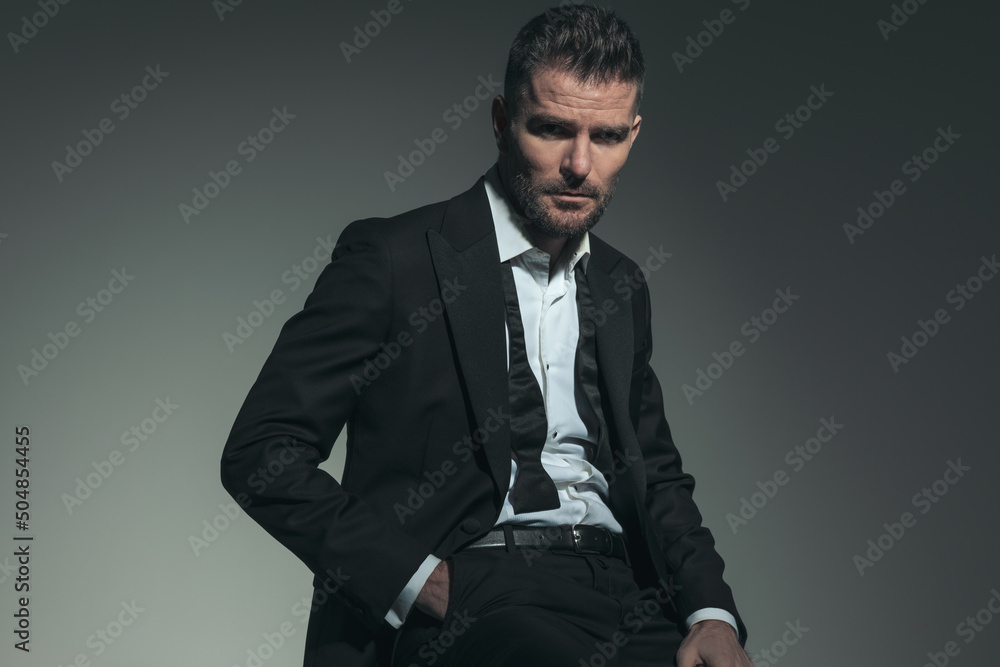 elegant businessman in his forties posing with hand in pocket elegant businessman in his forties posing with hand in pocket